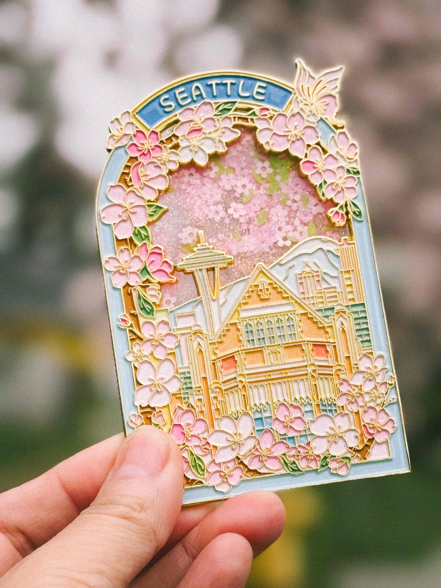 Seattle Magnet with a scenic view of Seattle, featuring cherry blossoms and UW library